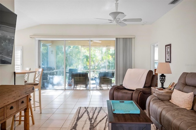 living room featuring ceiling fan, lofted ceiling, and light tile patterned flooring