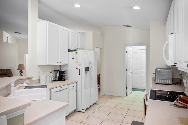 kitchen featuring sink, white cabinetry, white appliances, and light tile patterned floors