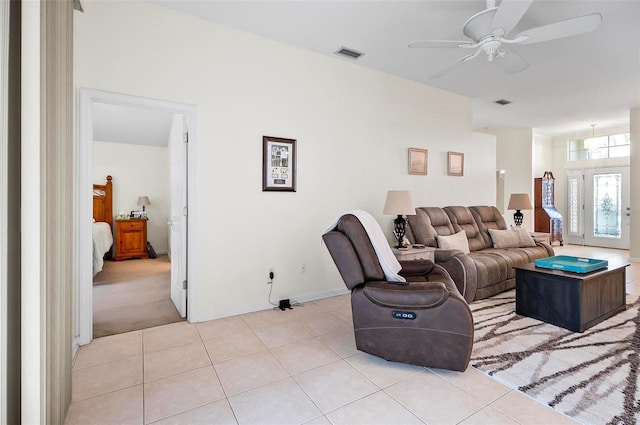 living room with ceiling fan and light tile patterned floors