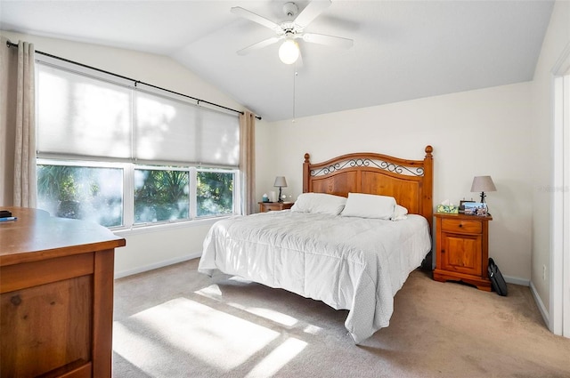 carpeted bedroom featuring vaulted ceiling and ceiling fan