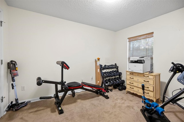 exercise area featuring a textured ceiling and carpet floors