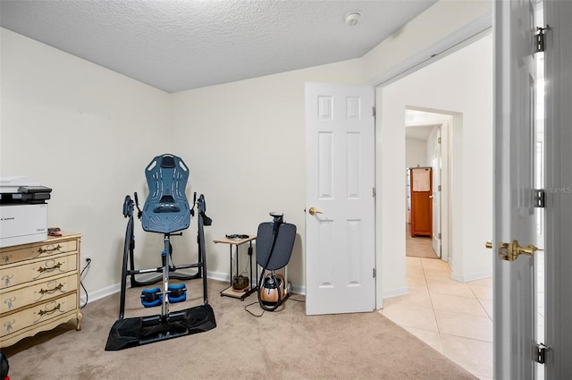 32 Shinnecock Dr, Palm Coast, FL 32137 - exercise room with light carpet, a textured ceiling, baseboards, and light tile patterned flooring