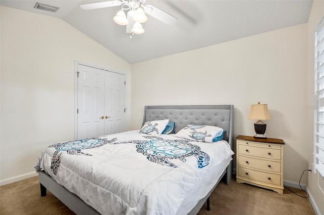 carpeted bedroom featuring a closet, vaulted ceiling, and ceiling fan