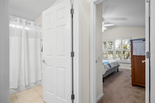 32 Shinnecock Dr, Palm Coast, FL 32137 - corridor with vaulted ceiling, light carpet, a textured ceiling, and baseboards