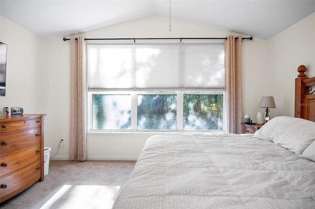 carpeted bedroom featuring multiple windows and lofted ceiling