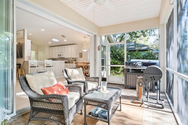 sunroom / solarium with ceiling fan