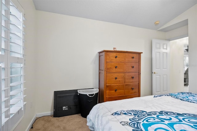 carpeted bedroom featuring lofted ceiling