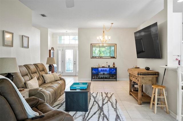 tiled living room with bar and an inviting chandelier