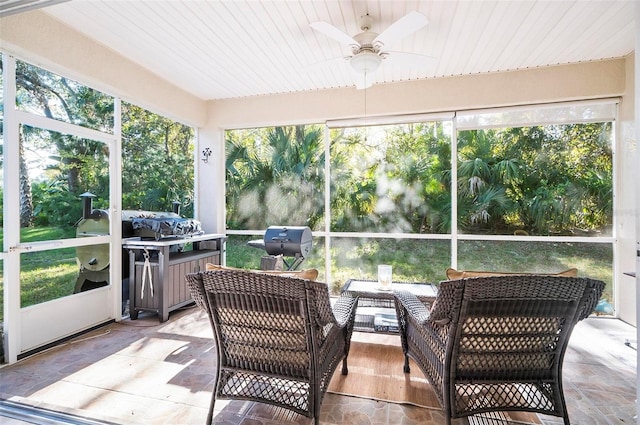 sunroom with plenty of natural light and ceiling fan