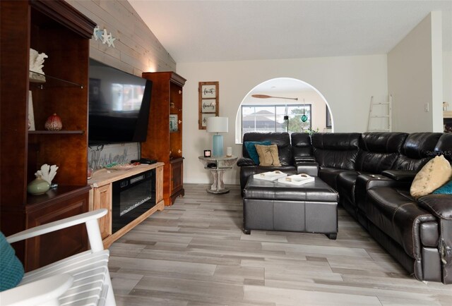 living room with light wood-type flooring and lofted ceiling