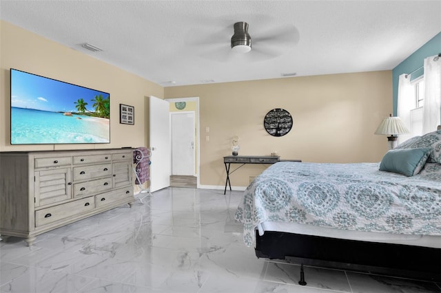 bedroom with a textured ceiling and ceiling fan