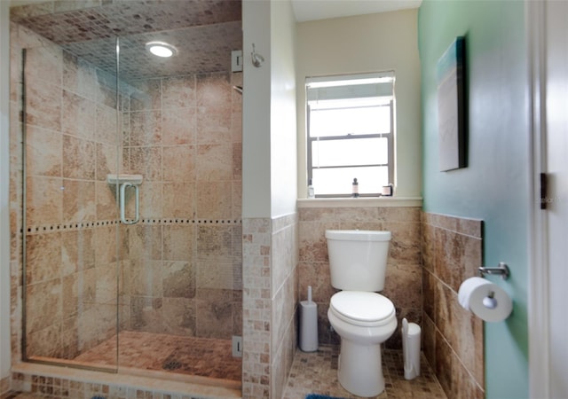 bathroom featuring tile walls, walk in shower, and toilet