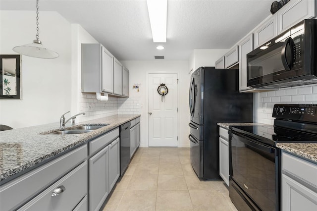 kitchen with black appliances, tasteful backsplash, gray cabinets, pendant lighting, and sink