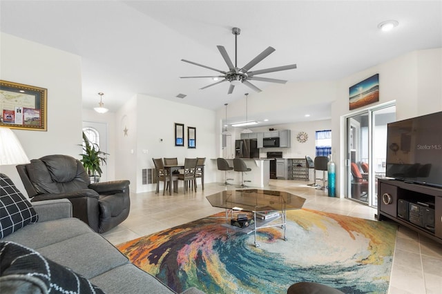 living room featuring a wealth of natural light, light tile patterned floors, and ceiling fan