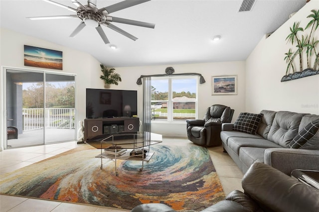 living room with lofted ceiling, light tile patterned floors, and ceiling fan