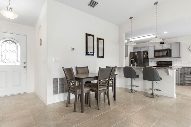 38 Colechester Ln, Palm Coast, FL 32137 - dining room with light tile patterned floors, baseboards, and recessed lighting