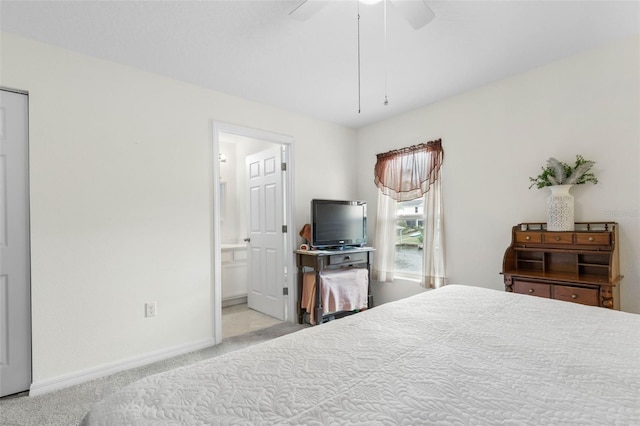 carpeted bedroom with ceiling fan and ensuite bath