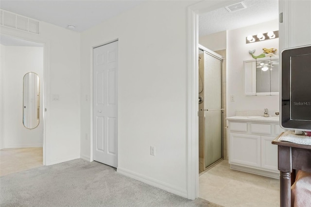38 Colechester Ln, Palm Coast, FL 32137 - full bathroom with a stall shower, vanity, carpet floors, and baseboards