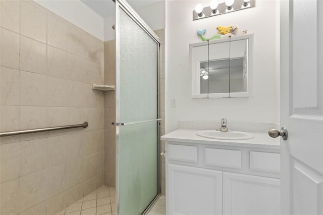 bathroom featuring vanity, tile patterned floors, and a shower with shower door