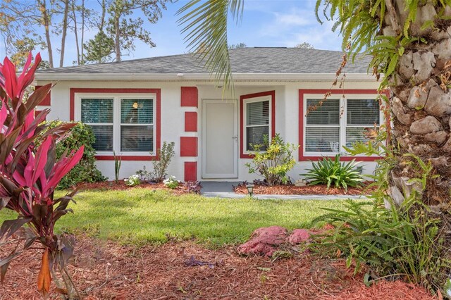 single story home with a front lawn