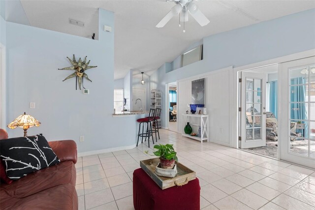 tiled living room with french doors, high vaulted ceiling, and ceiling fan