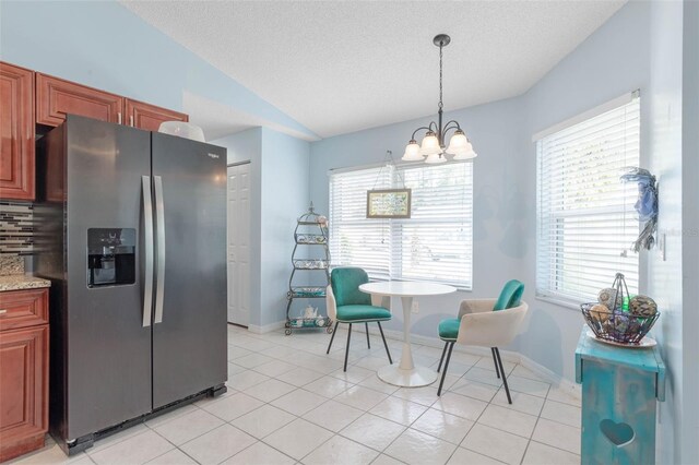 kitchen with hanging light fixtures, a textured ceiling, tasteful backsplash, and stainless steel fridge with ice dispenser