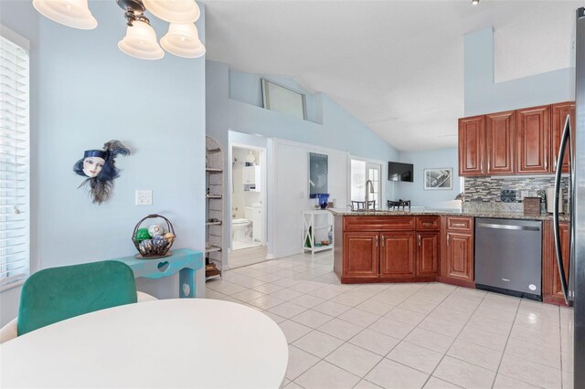 kitchen with dishwasher, kitchen peninsula, light tile patterned flooring, and light stone counters