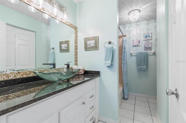 bathroom featuring shower / bath combination with curtain, backsplash, vanity, a textured ceiling, and tile patterned flooring