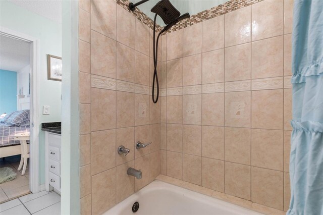 bathroom with vanity, tile patterned flooring, and shower / bathtub combination with curtain