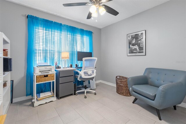 office featuring light tile patterned flooring, a textured ceiling, and ceiling fan