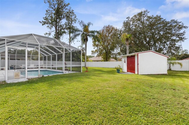 view of yard with a storage shed, glass enclosure, and a fenced in pool