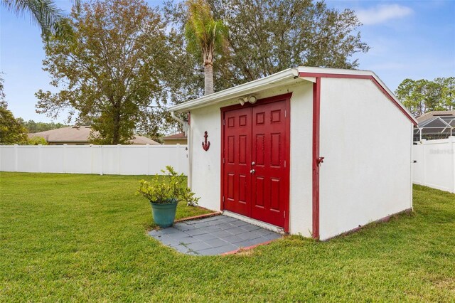 view of outbuilding featuring a lawn