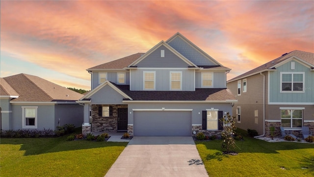 craftsman-style home featuring a garage and a lawn