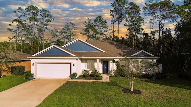 view of front of home with a lawn and a garage