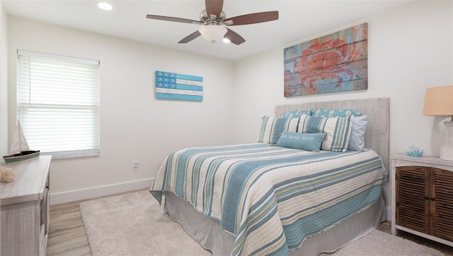 bedroom with baseboards, recessed lighting, light wood finished floors, and a ceiling fan