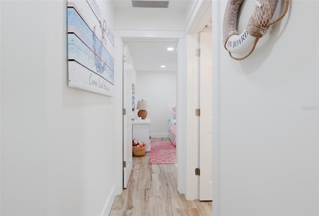 corridor with light hardwood / wood-style floors