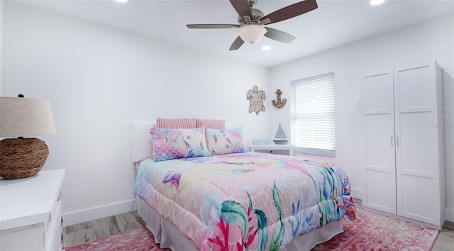 bedroom featuring light hardwood / wood-style floors and ceiling fan