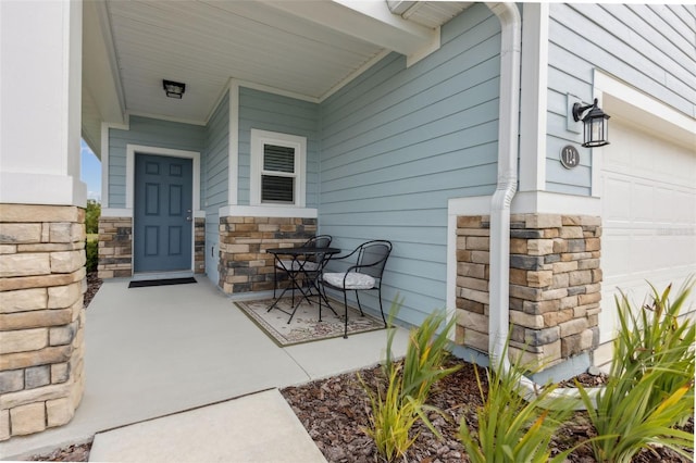 view of exterior entry with covered porch