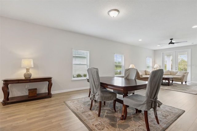 dining area with ceiling fan, french doors, light hardwood / wood-style floors, and plenty of natural light