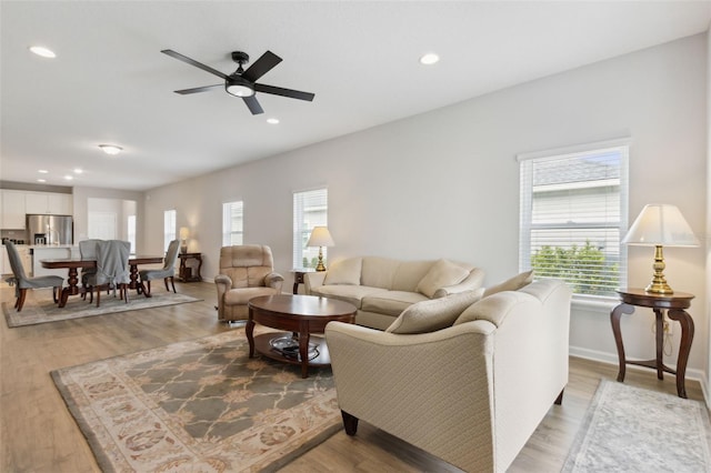 living room with hardwood / wood-style flooring and ceiling fan