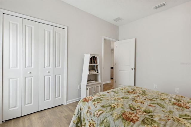 bedroom featuring light hardwood / wood-style flooring and a closet