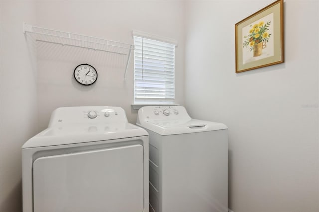 clothes washing area with washing machine and clothes dryer