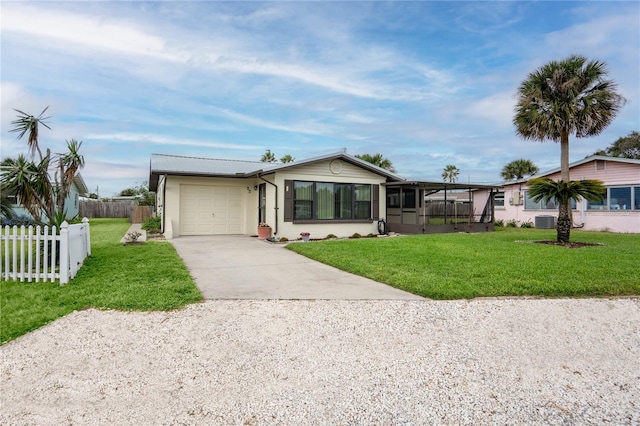 ranch-style house with central AC unit, a front yard, a sunroom, and a garage