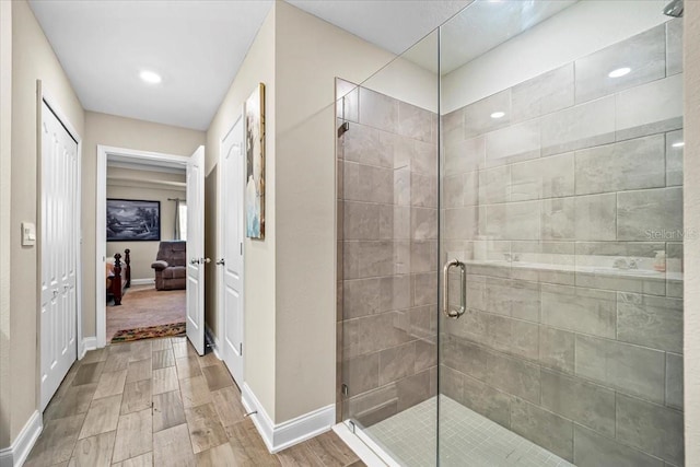 bathroom featuring a shower with shower door