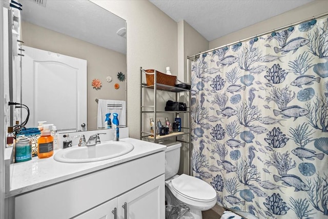 bathroom featuring vanity, toilet, a textured ceiling, and a shower with shower curtain