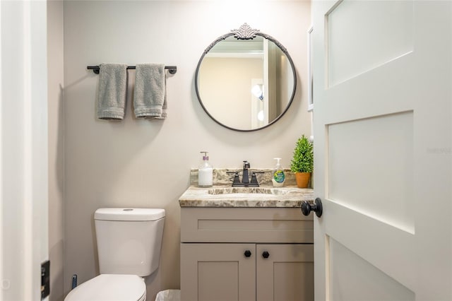 bathroom with toilet and vanity