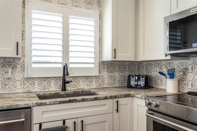 kitchen with white cabinetry, appliances with stainless steel finishes, and sink