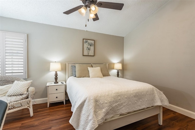 bedroom with a textured ceiling, dark wood-type flooring, ceiling fan, and lofted ceiling