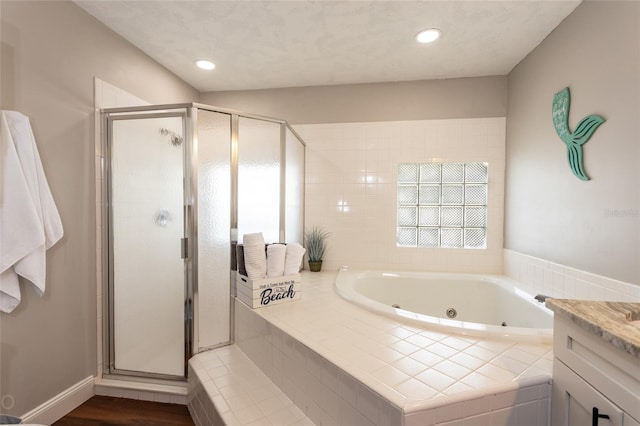 bathroom featuring vanity, hardwood / wood-style flooring, and separate shower and tub