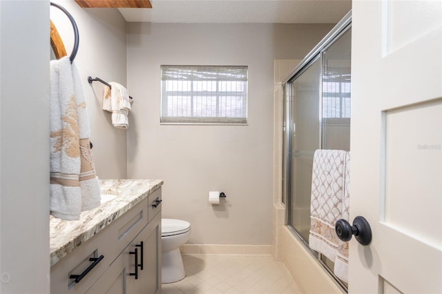 full bathroom featuring toilet, tile patterned flooring, a textured ceiling, combined bath / shower with glass door, and vanity